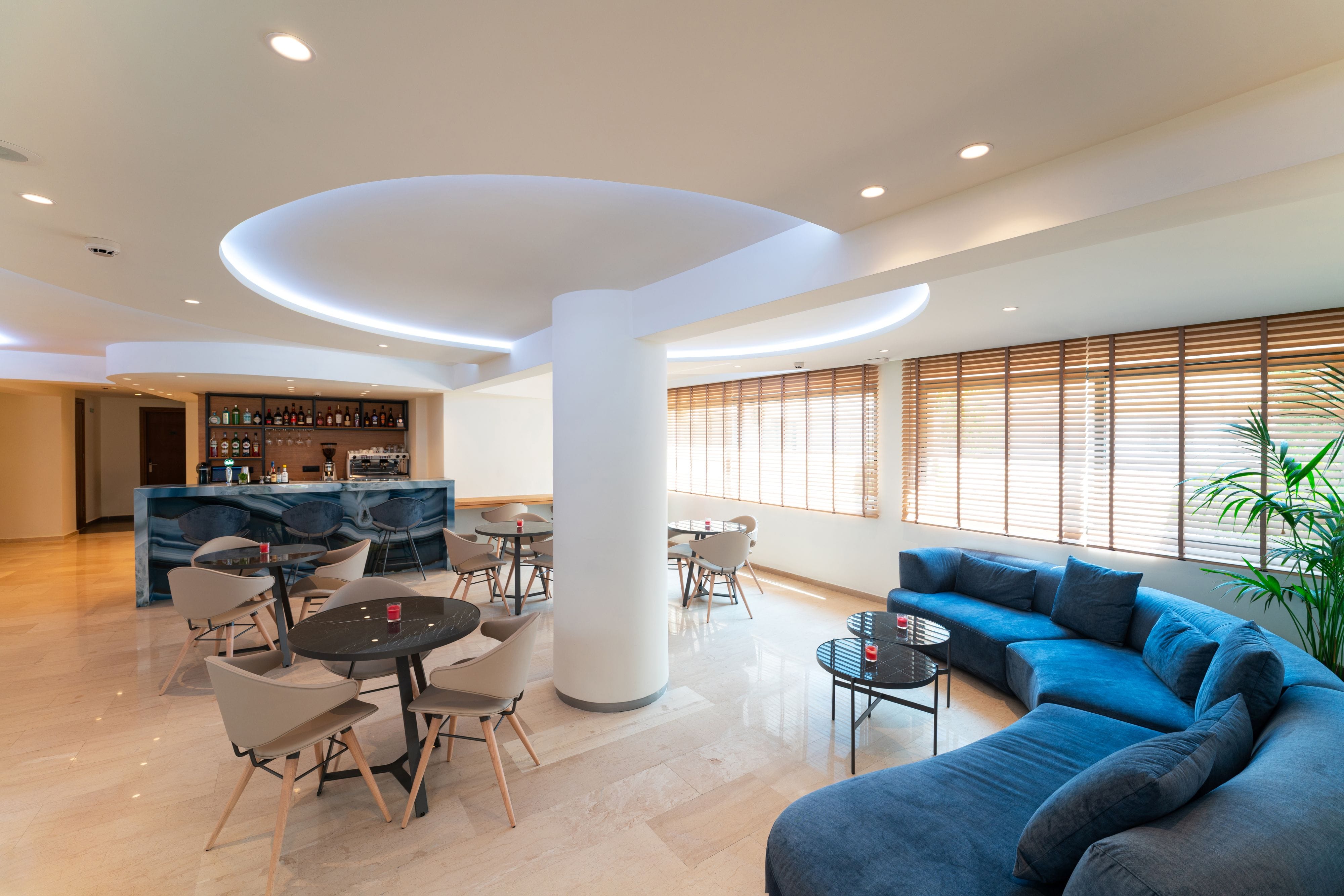 a room with a couch and chairs