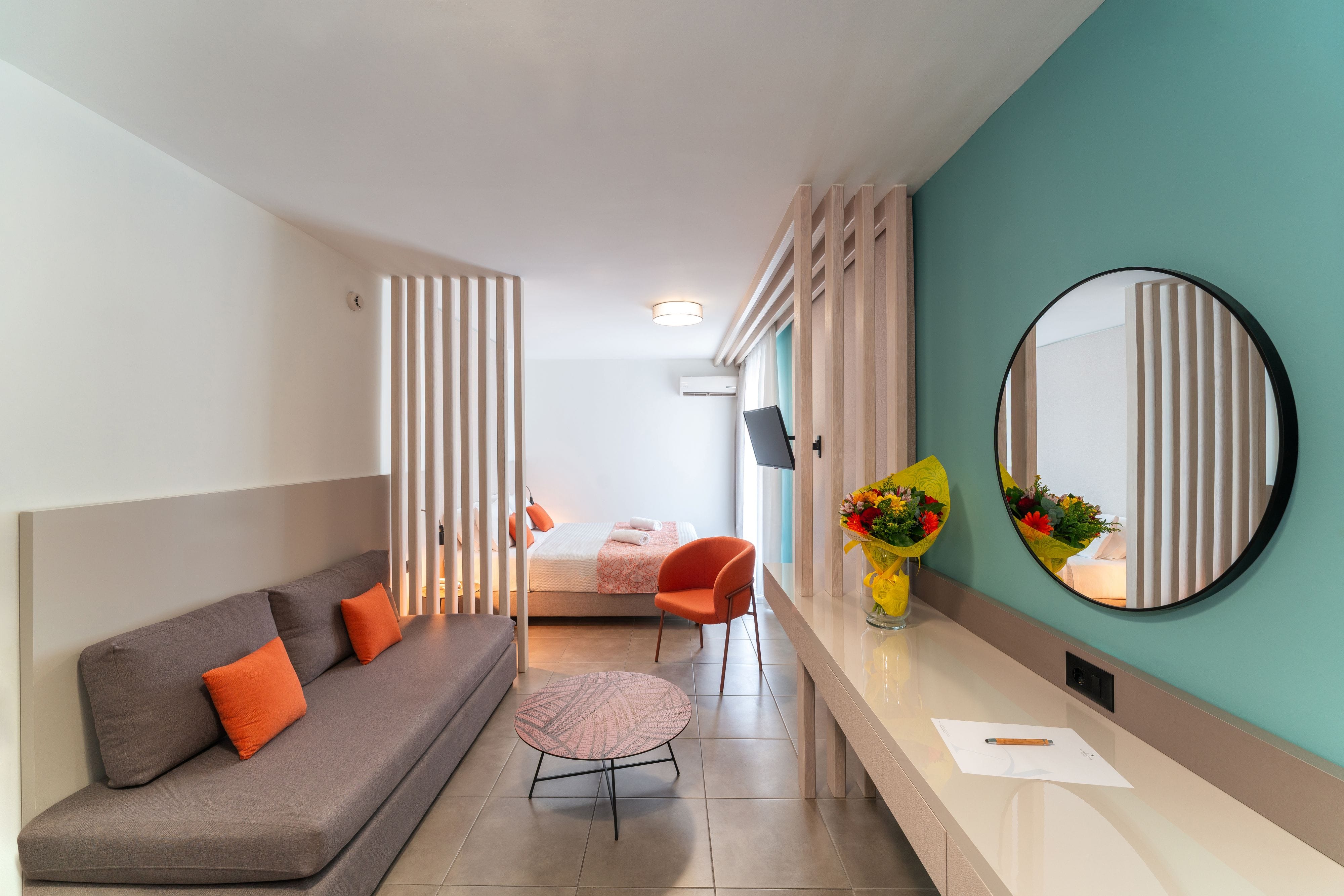 a room with a couch and a mirror