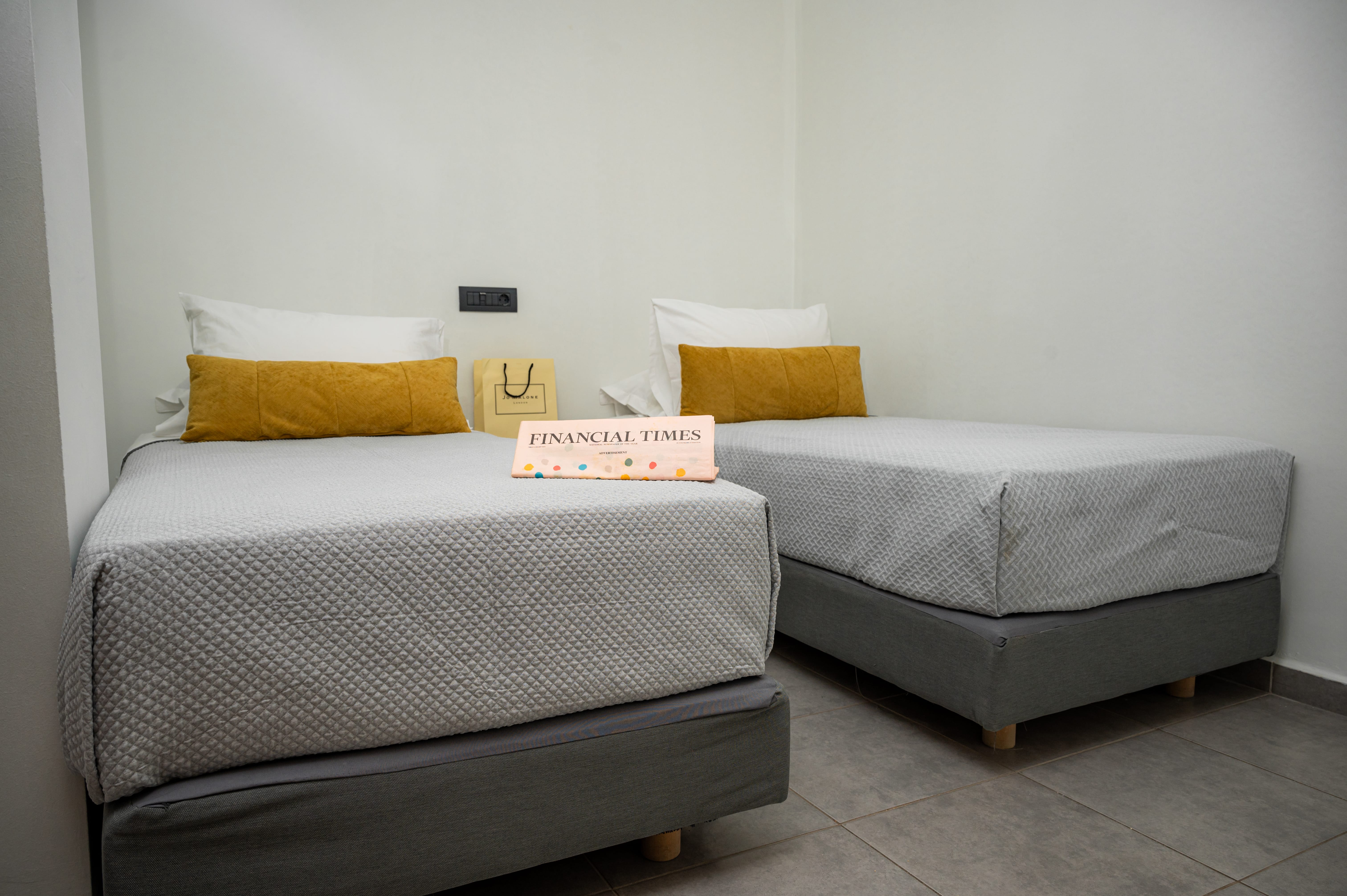 a couple of beds in a room