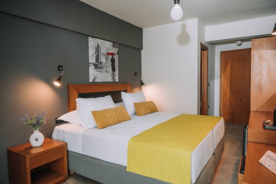 a bed with yellow pillows