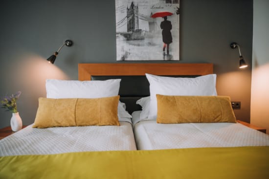 a couple of beds with pillows