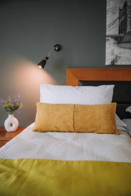 a bed with a lamp on it