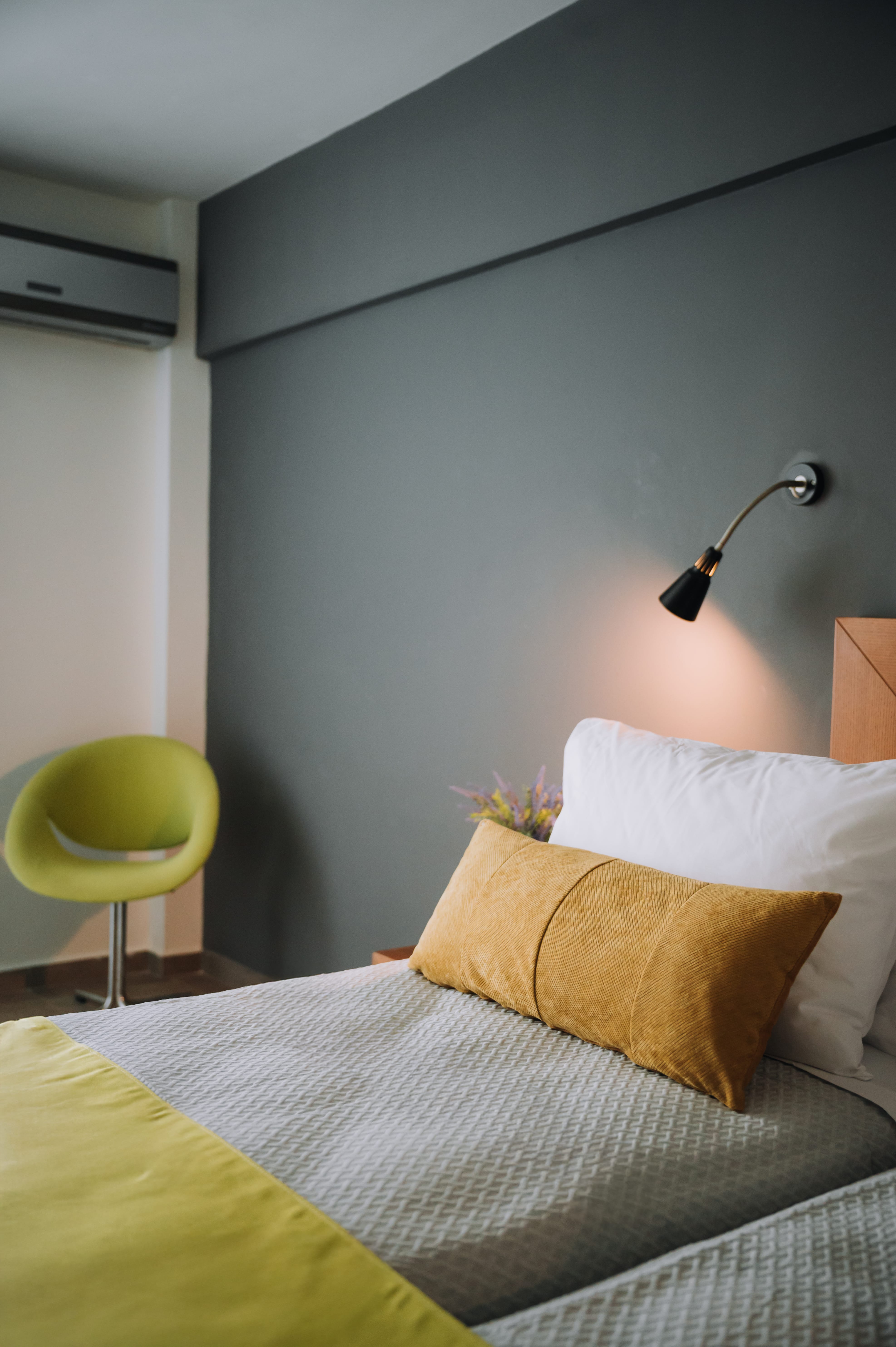 a bed with pillows and a lamp