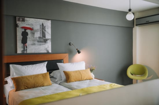 a bed with a yellow chair