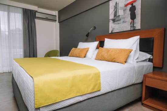 a bed with a yellow comforter