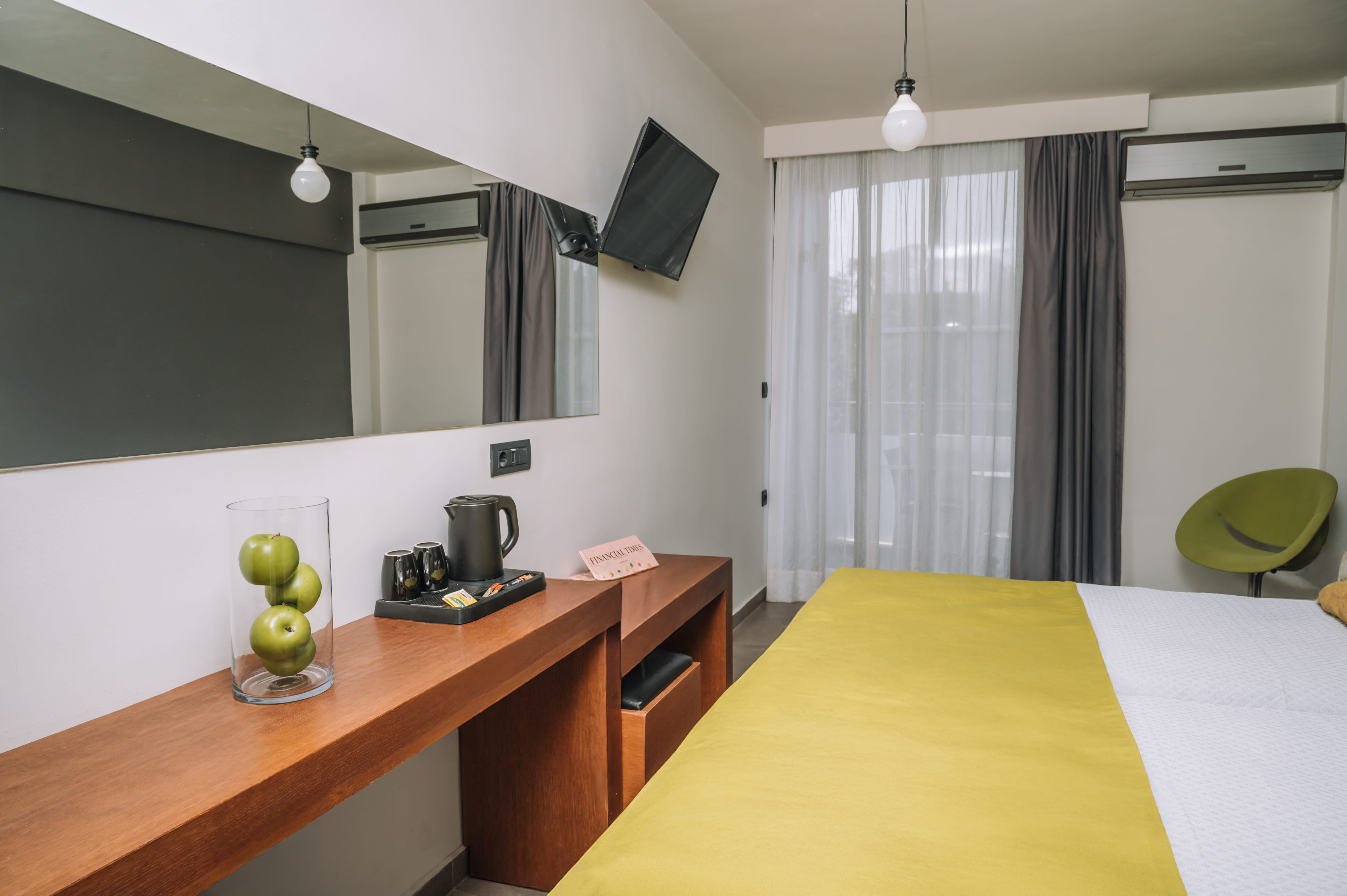 a hotel room with a bed and a desk