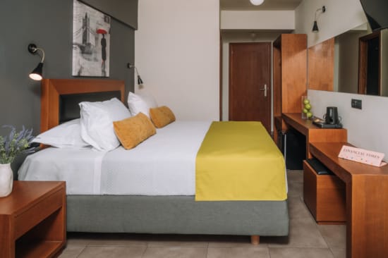 a bed with a yellow chair