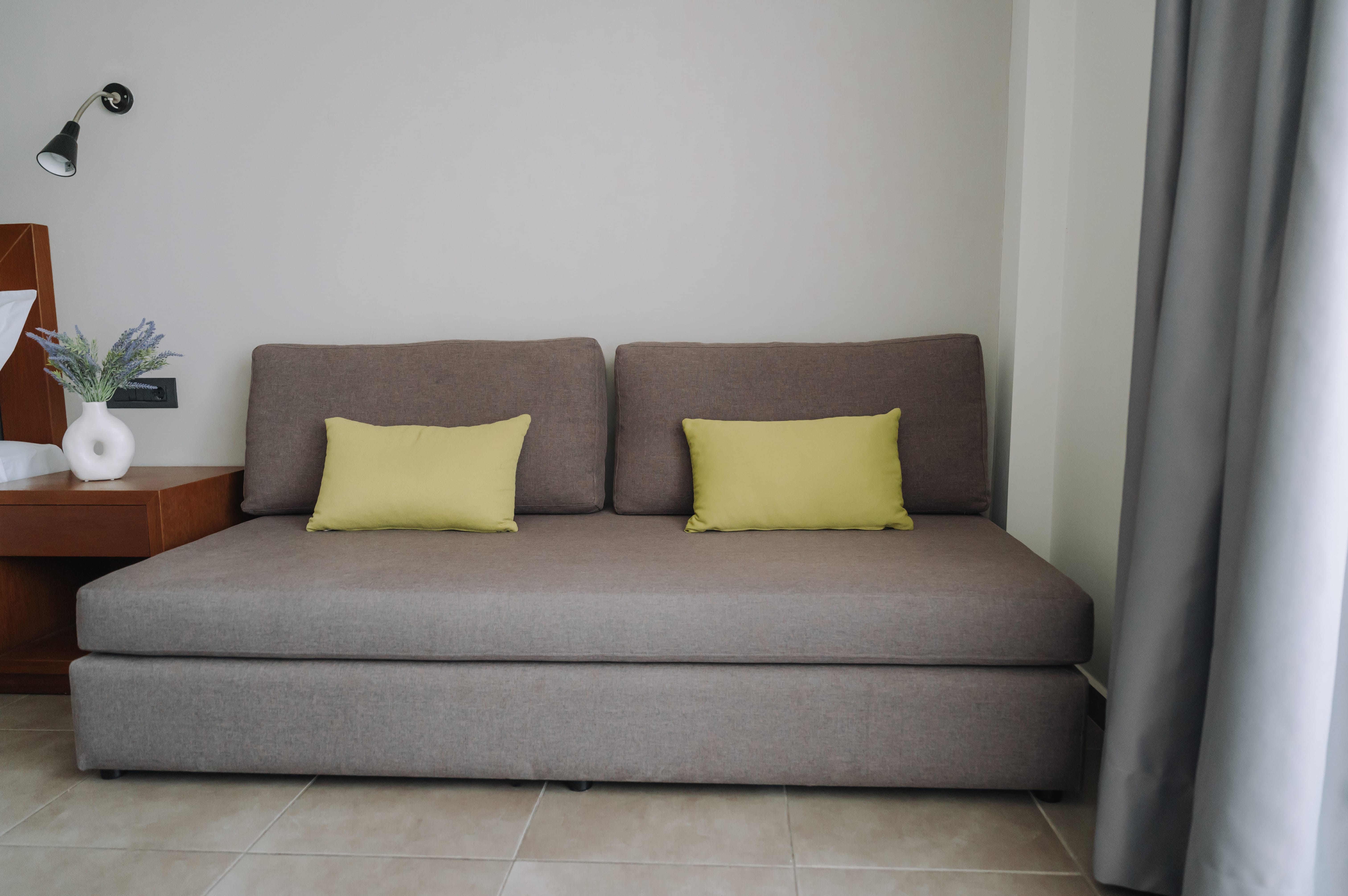a couch with yellow pillows