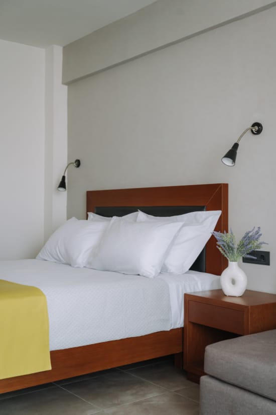 a bed with a white pillow