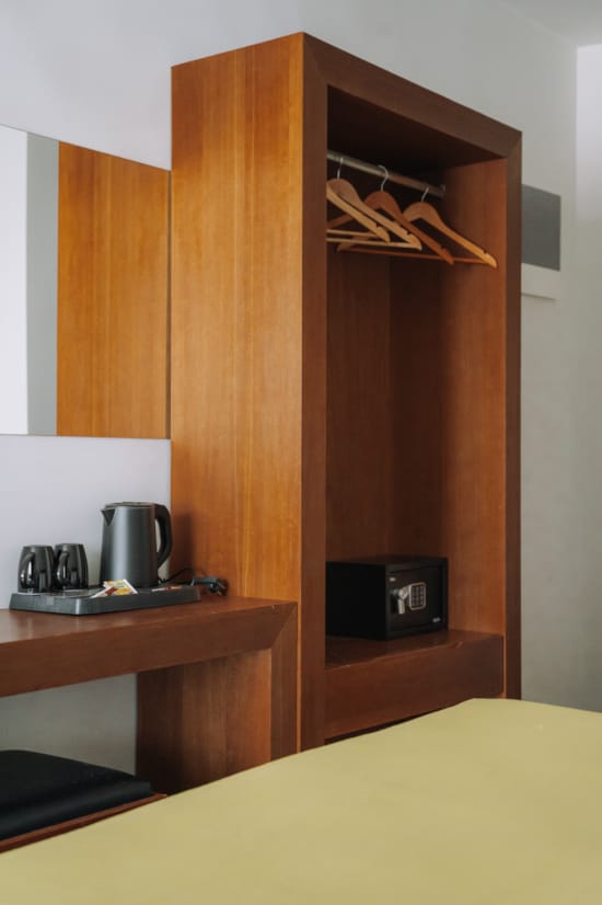 a wooden cabinet with a microwave and coffee maker on it