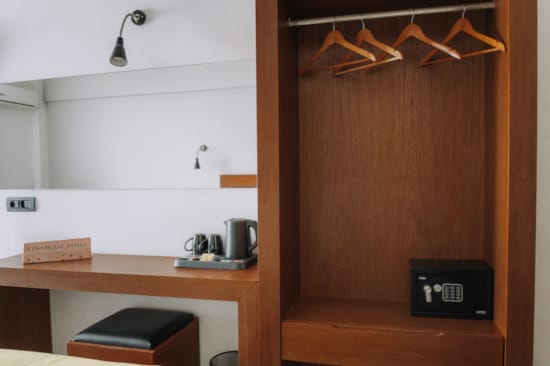 a room with a desk and a cabinet with a light