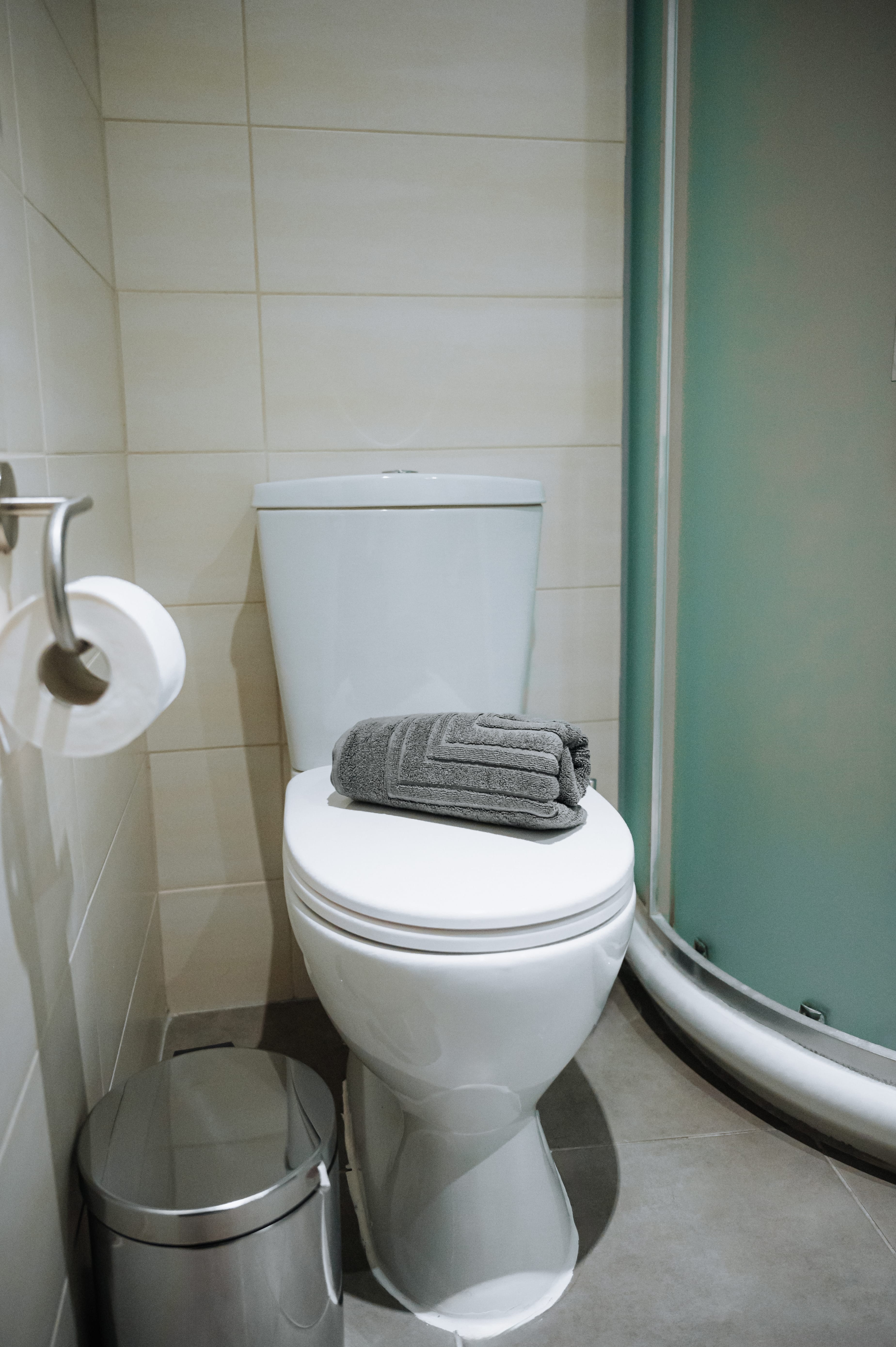 a toilet with a towel on the tank