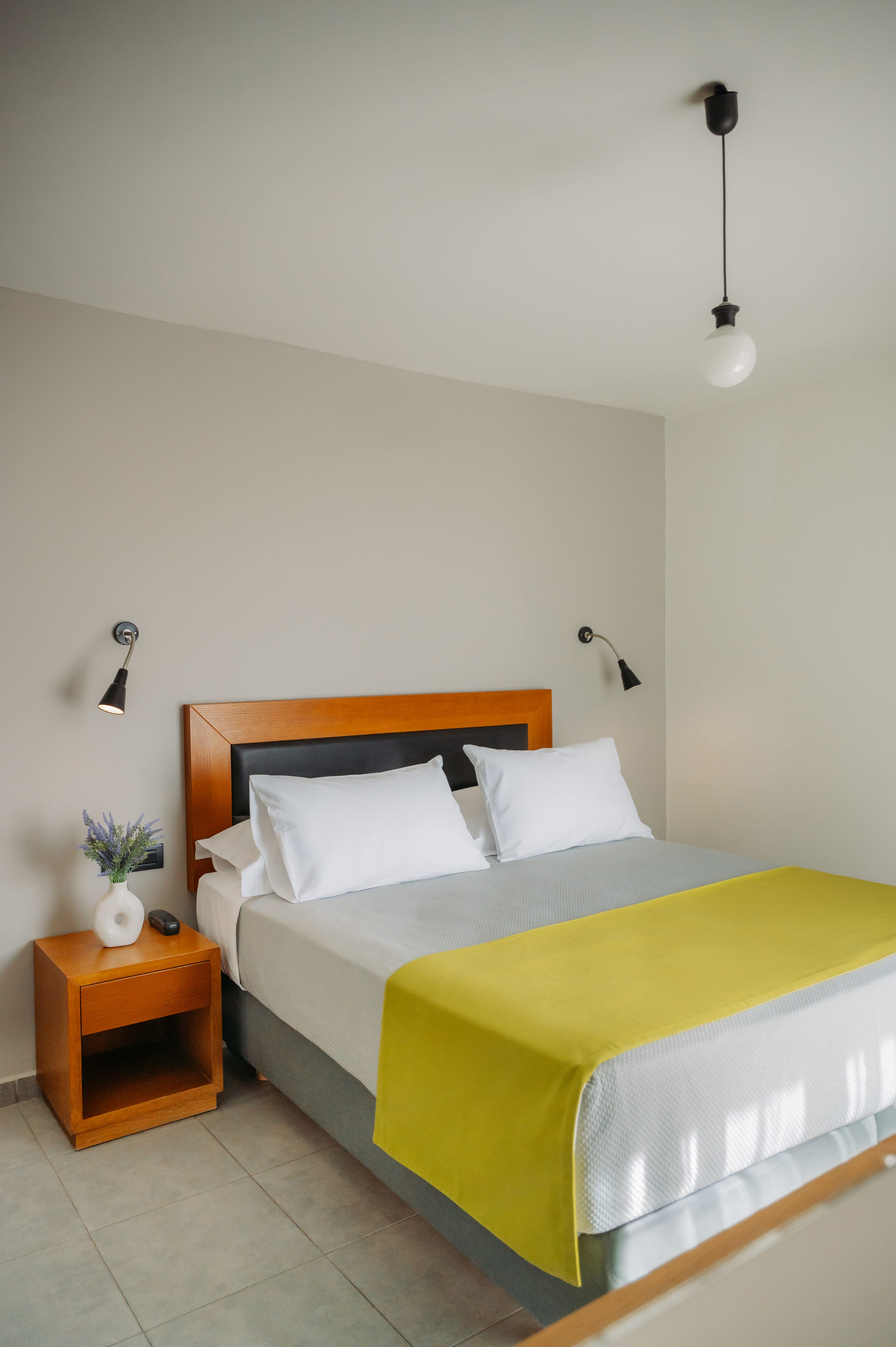 a bed with a yellow bed spread