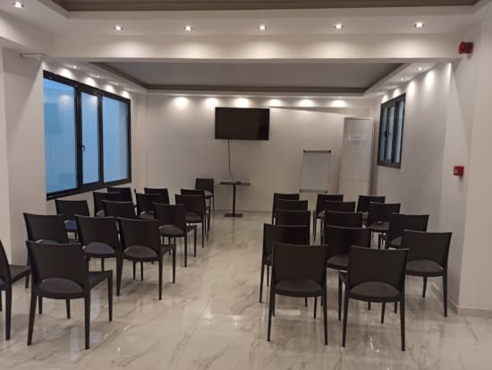 a room with a large group of chairs and tables