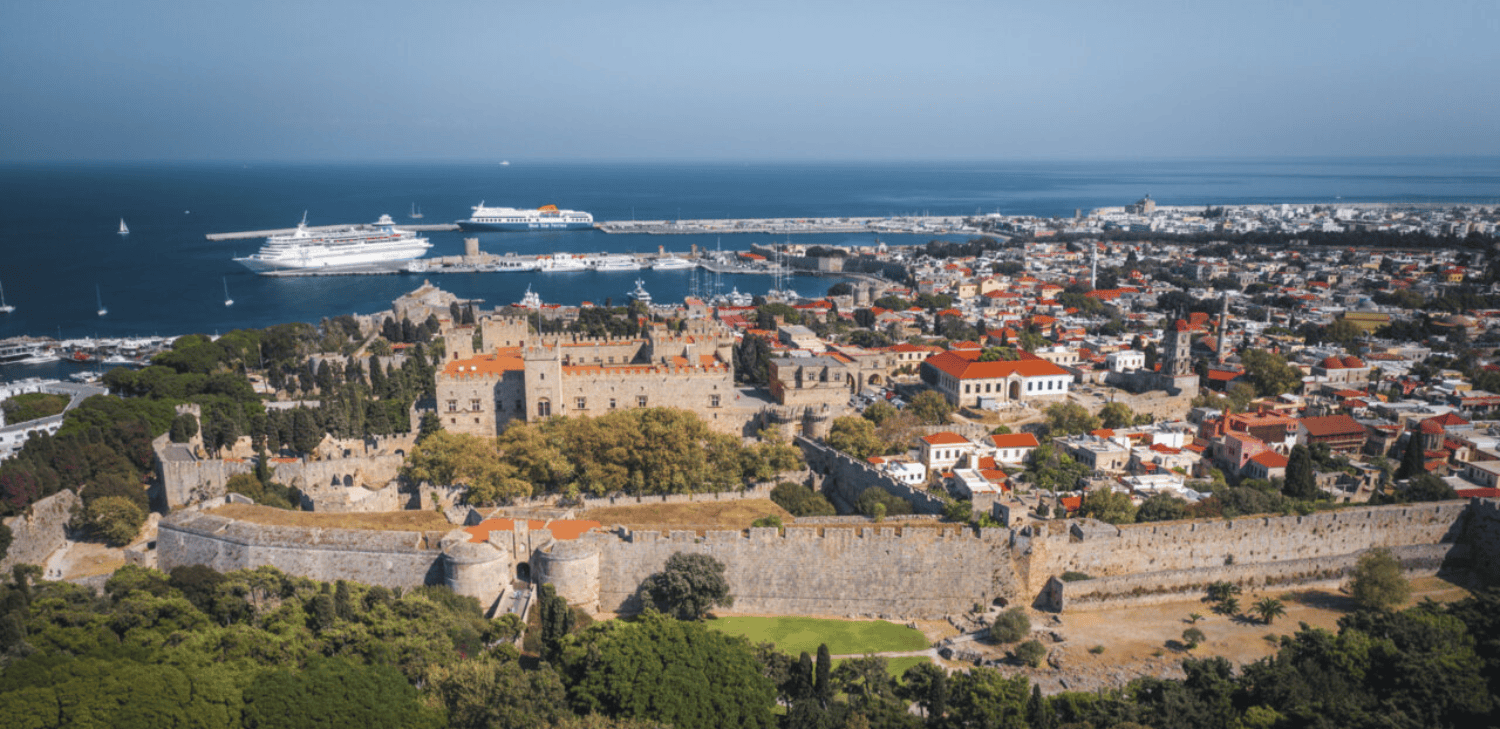 a city with a body of water in the background