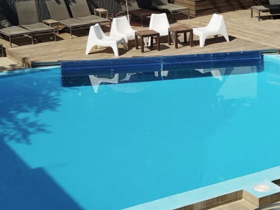a pool with chairs around it