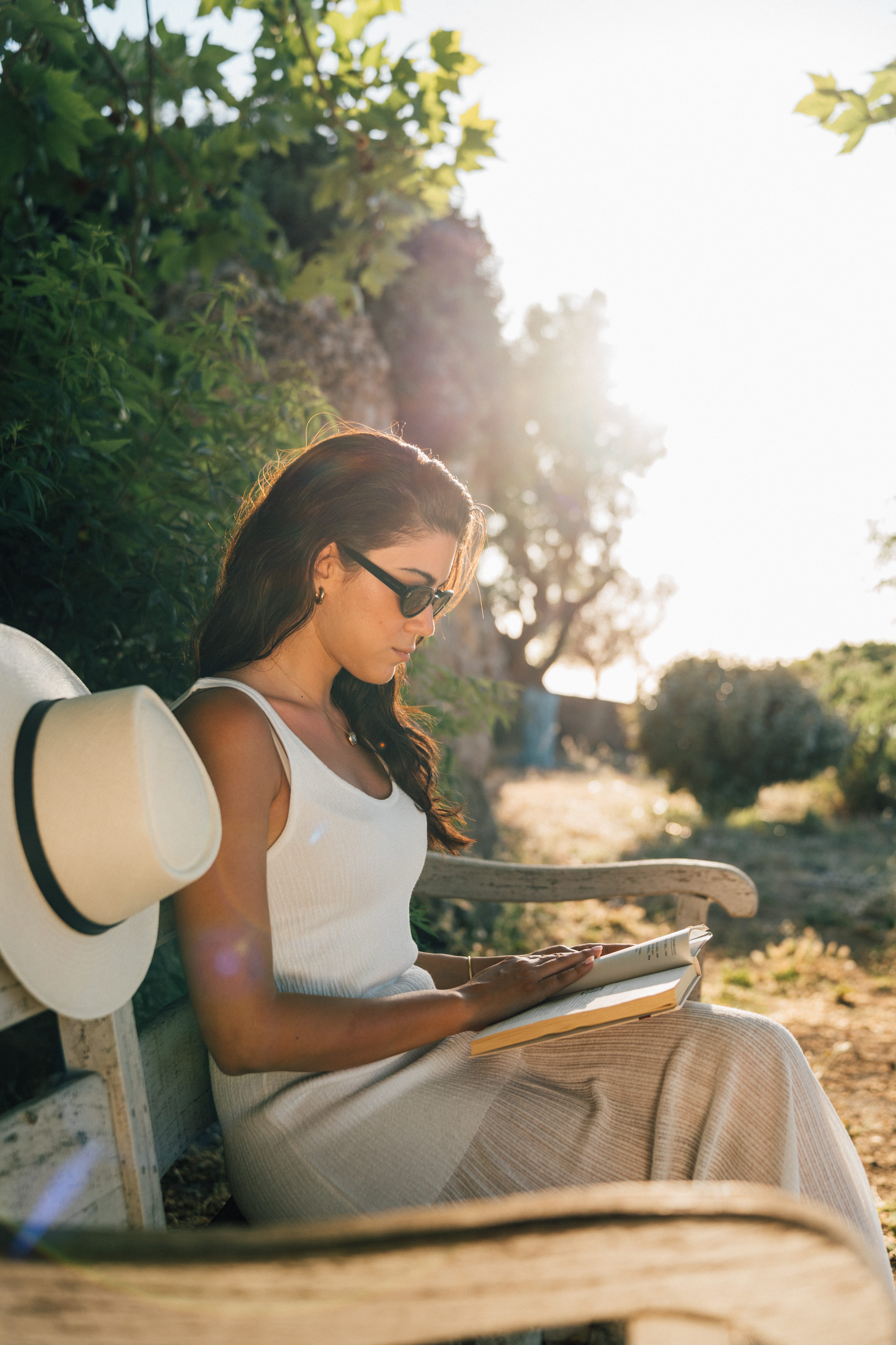 a woman sitting outside on a bench