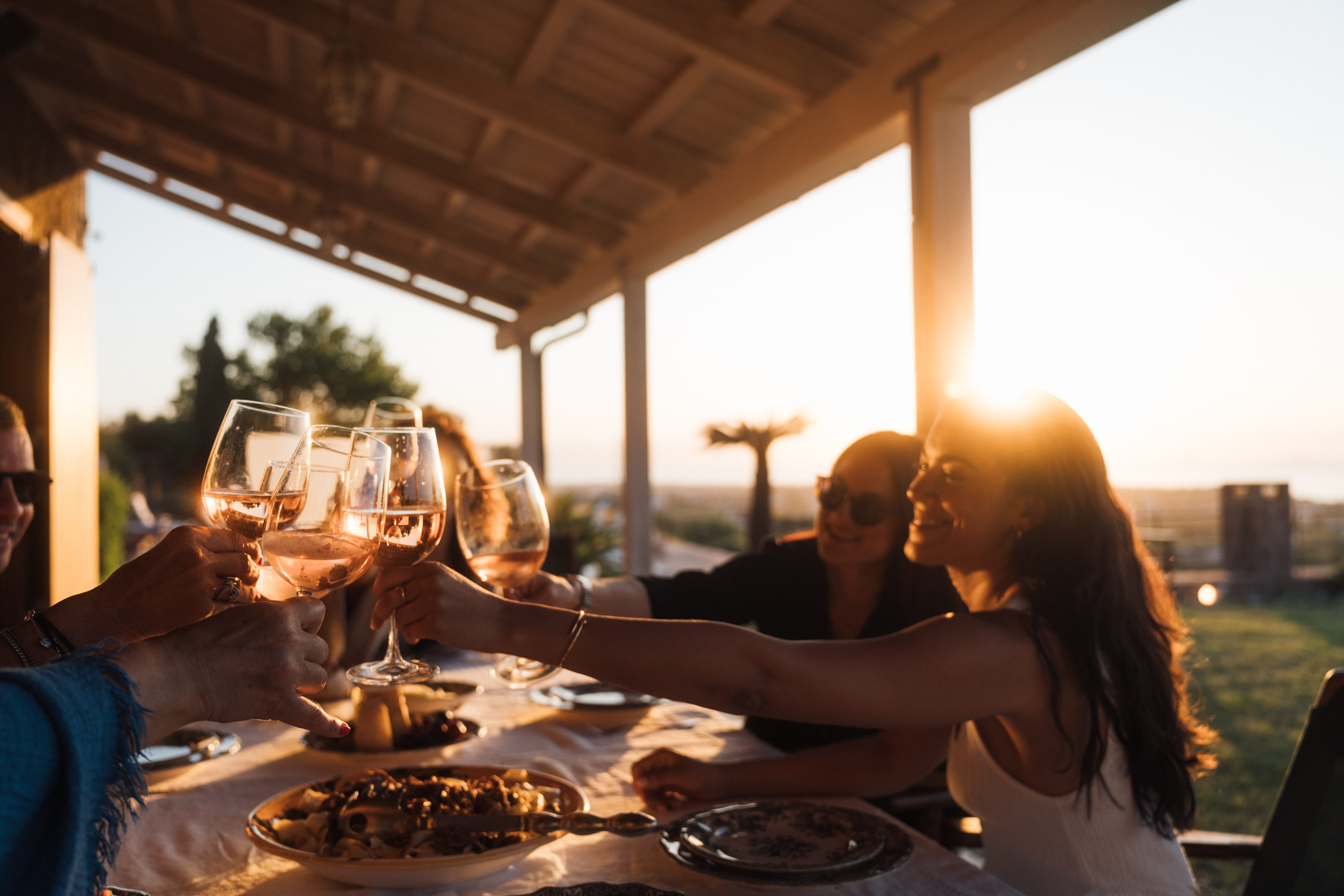 a group of people sitting at a table with food