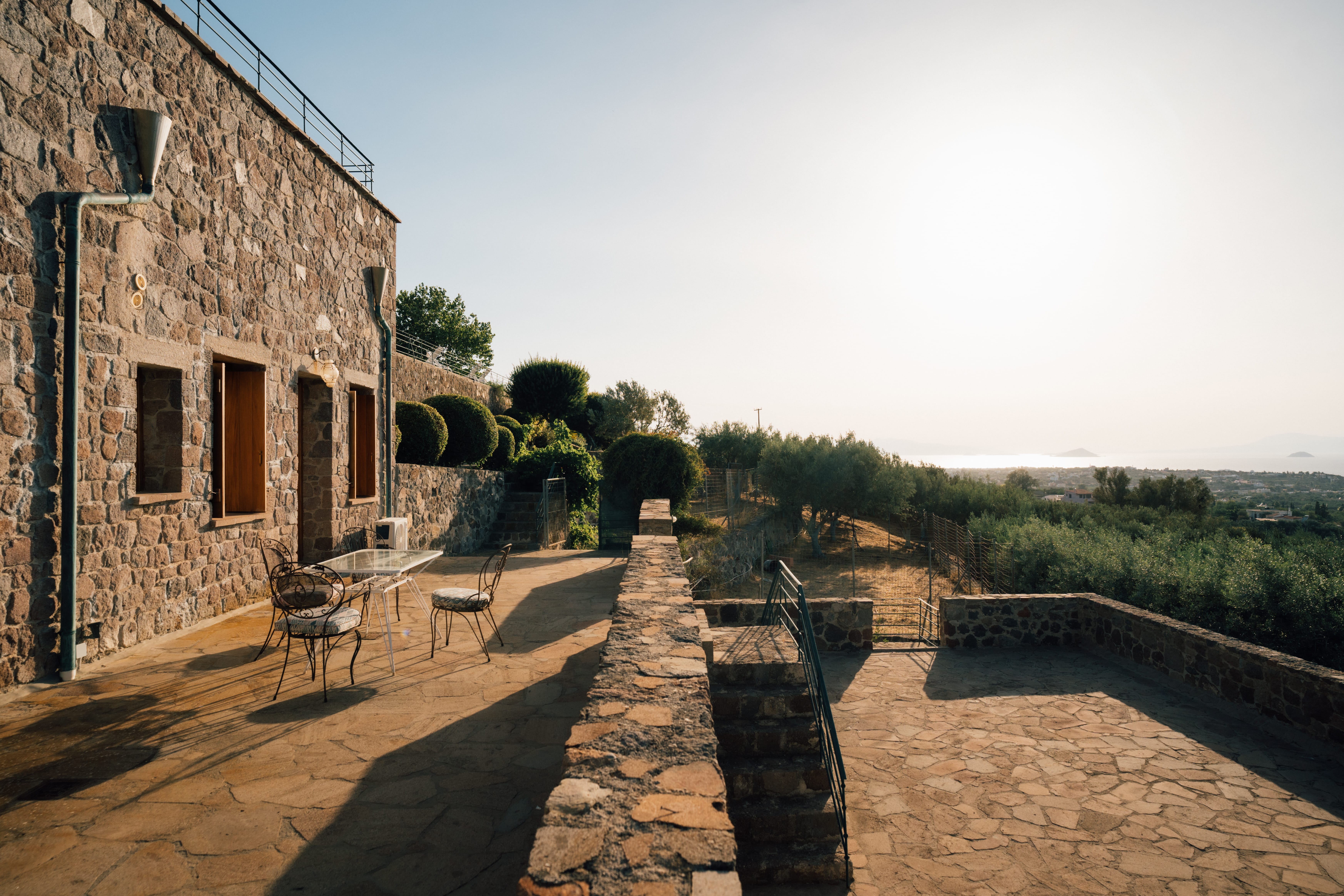 a stone walkway with chairs and tables