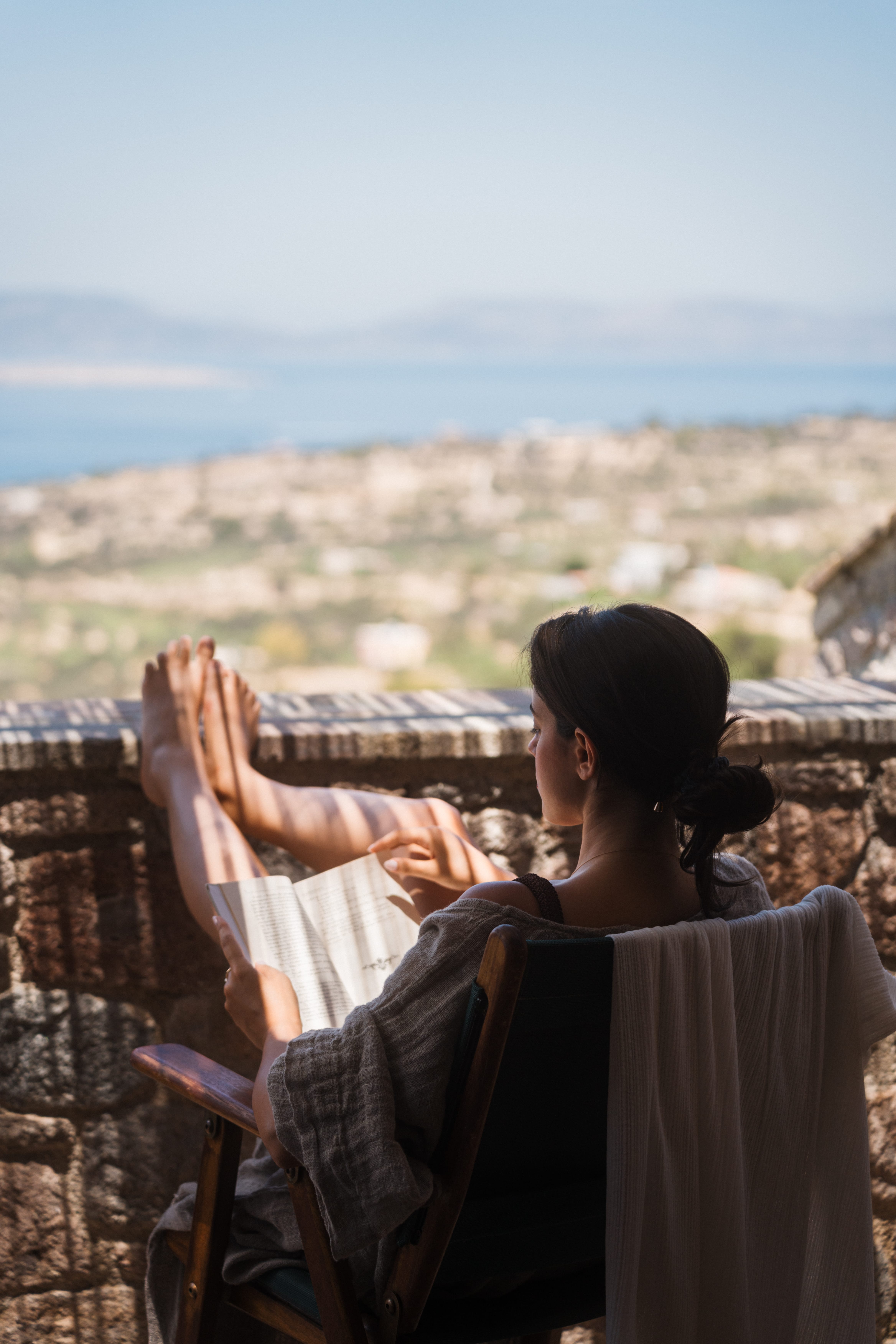 a person sitting on a chair overlooking a city