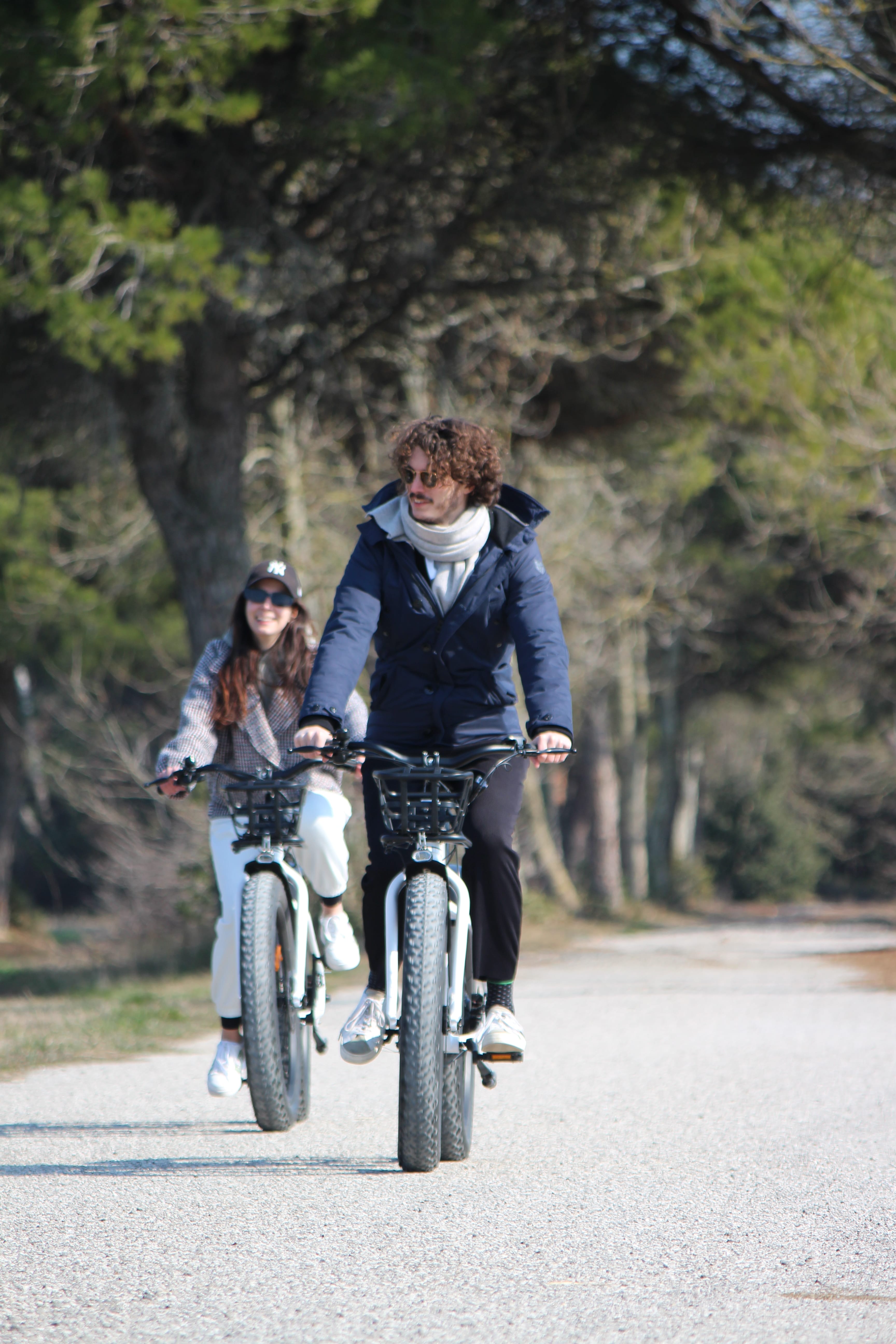 a man and a woman riding bicycles