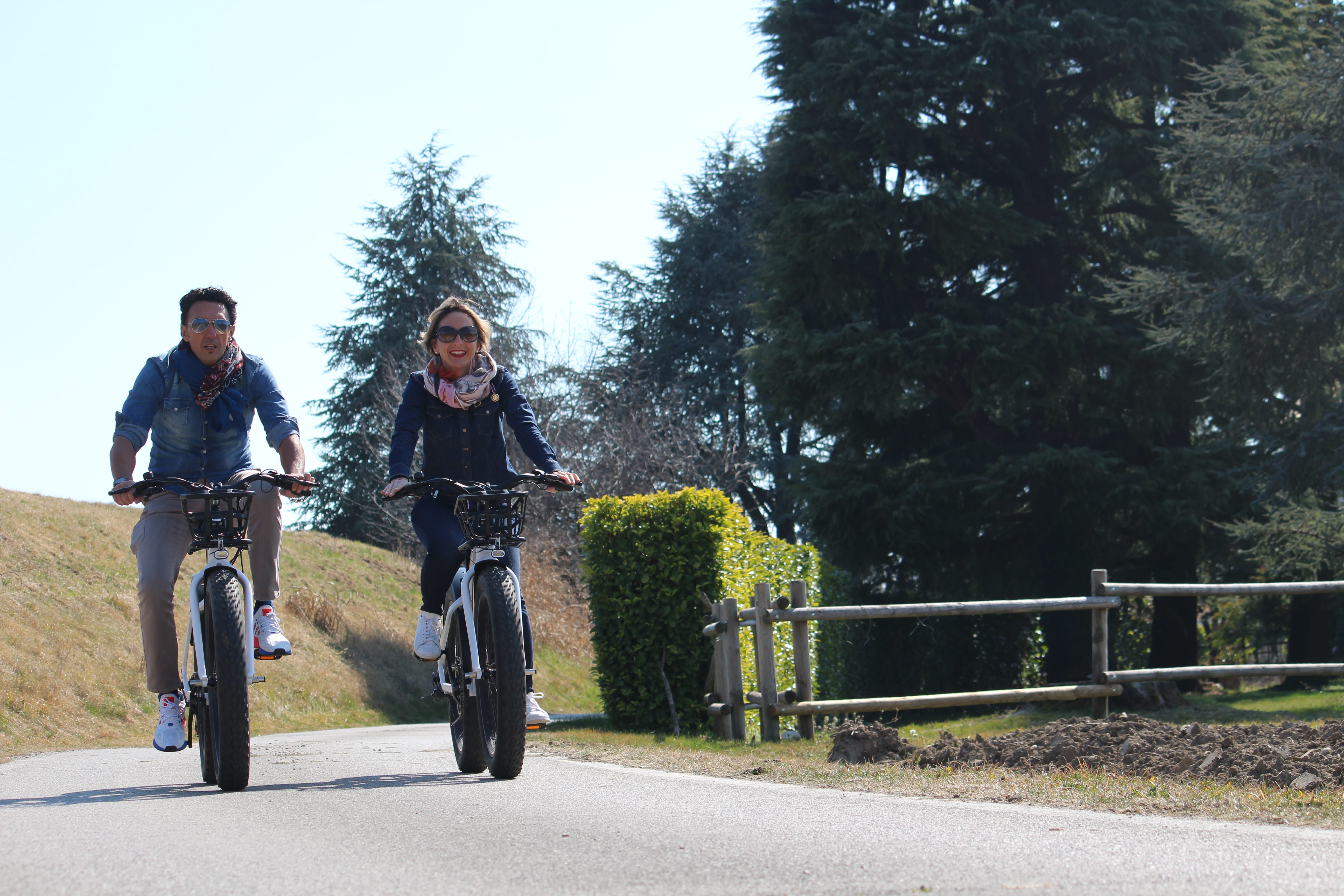 a man and a woman riding bicycles