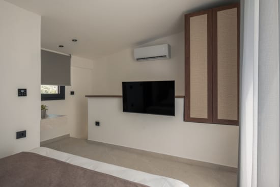 a room with a tv and cabinets