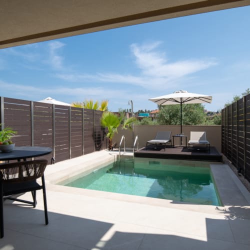 a pool with a table and chairs