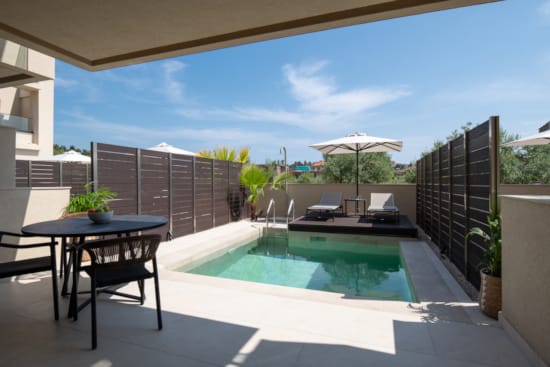 a pool with a table and chairs