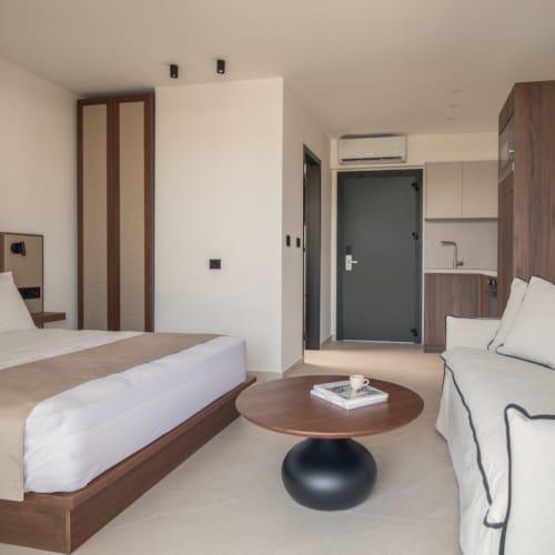 a hotel room with a bed and a coffee table
