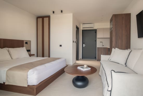 a hotel room with a bed and a coffee table