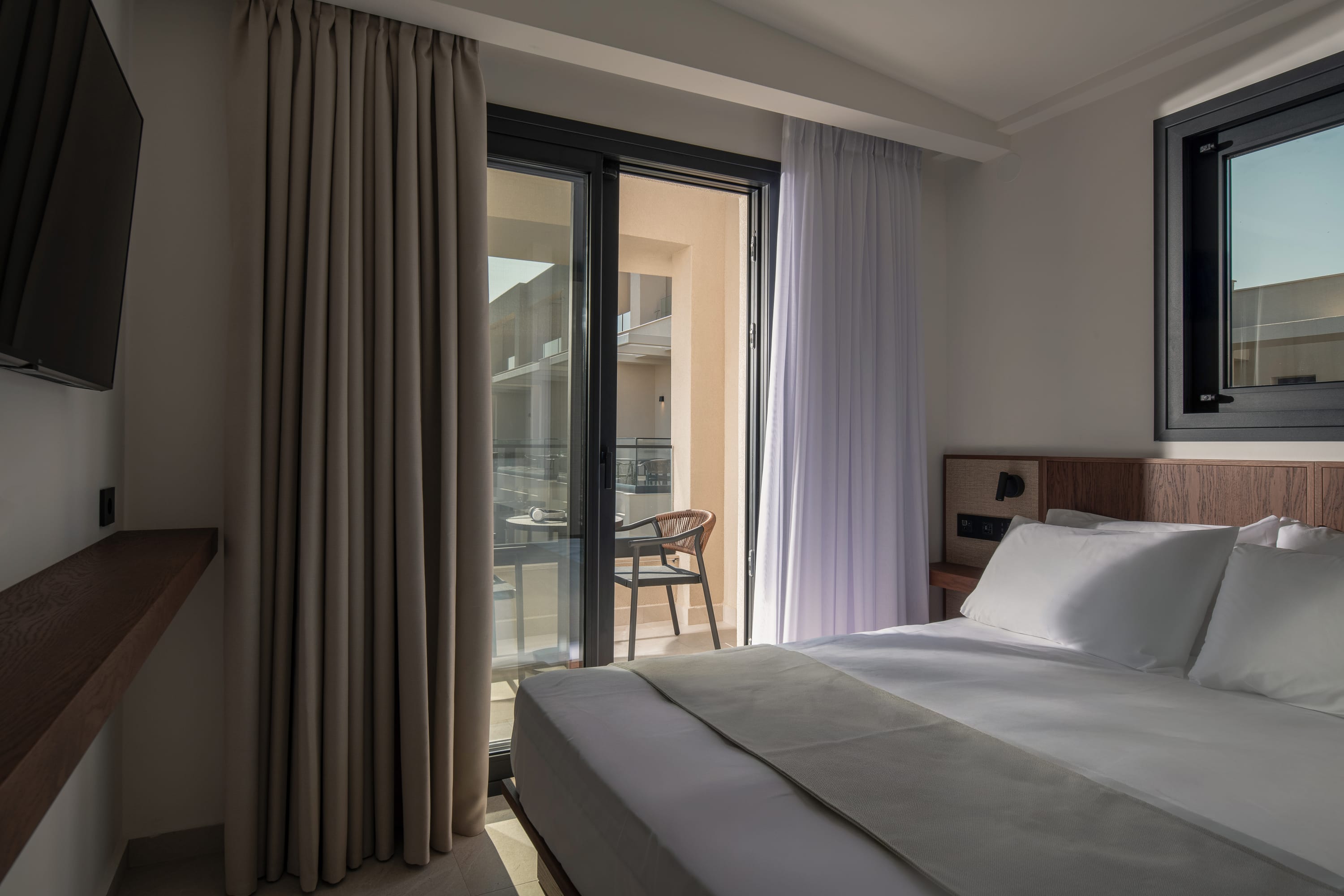 a bedroom with a large glass door