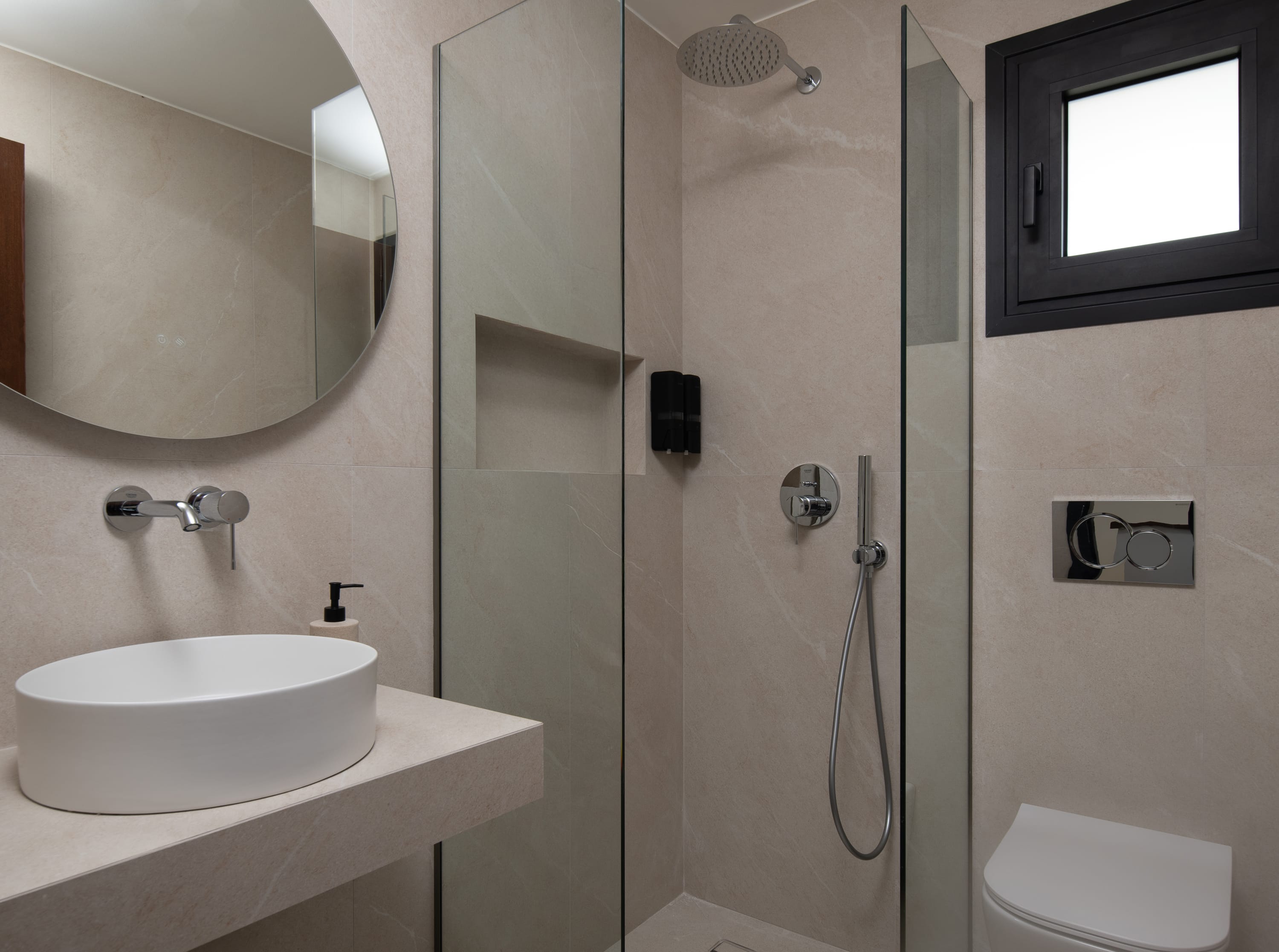 a bathroom with a sink and a shower unit