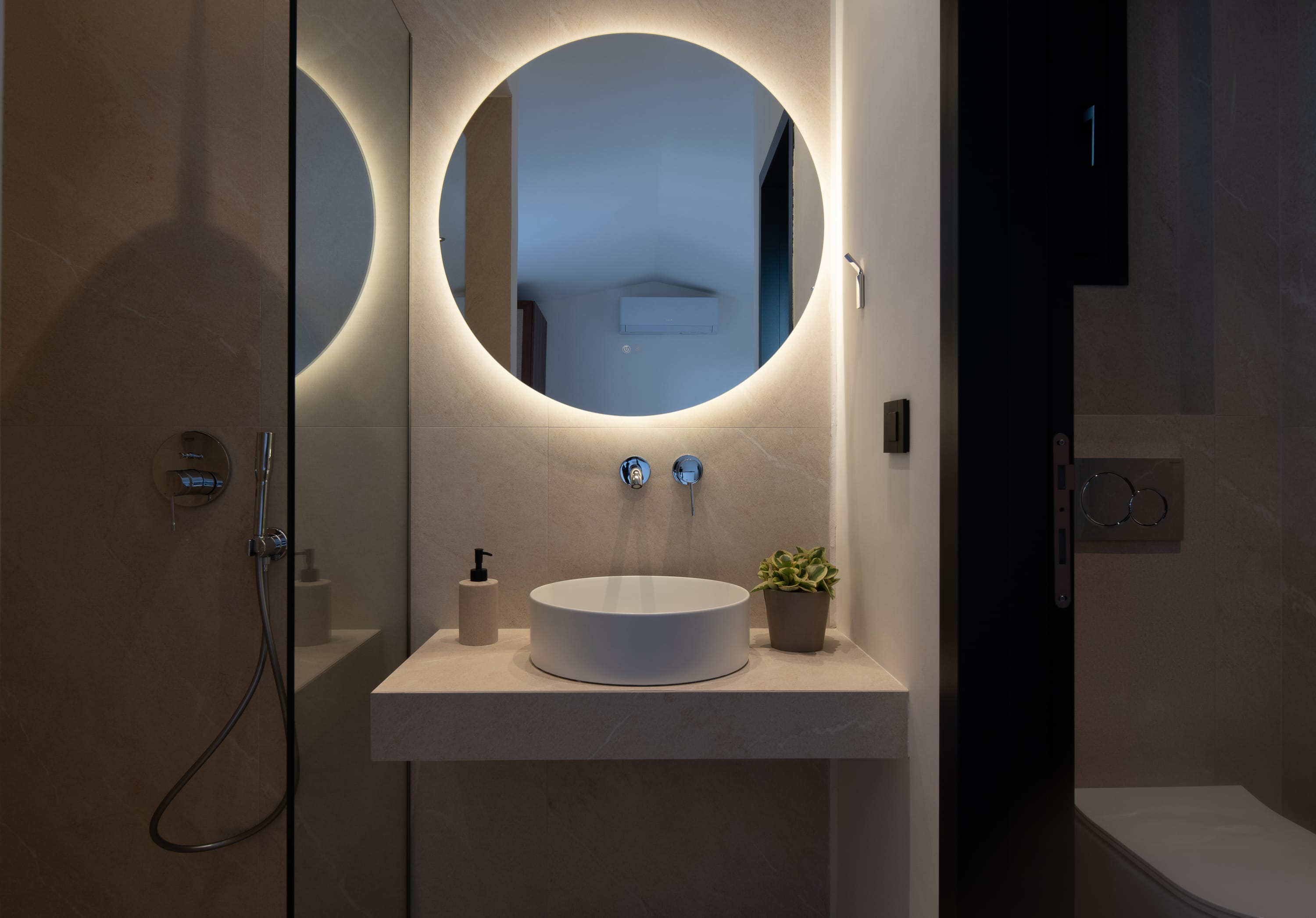 a bathroom with a round mirror
