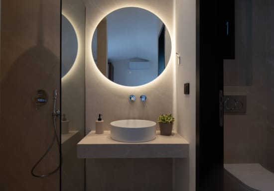 a bathroom with a round mirror