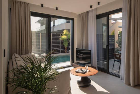 a room with a glass door and a plant in it