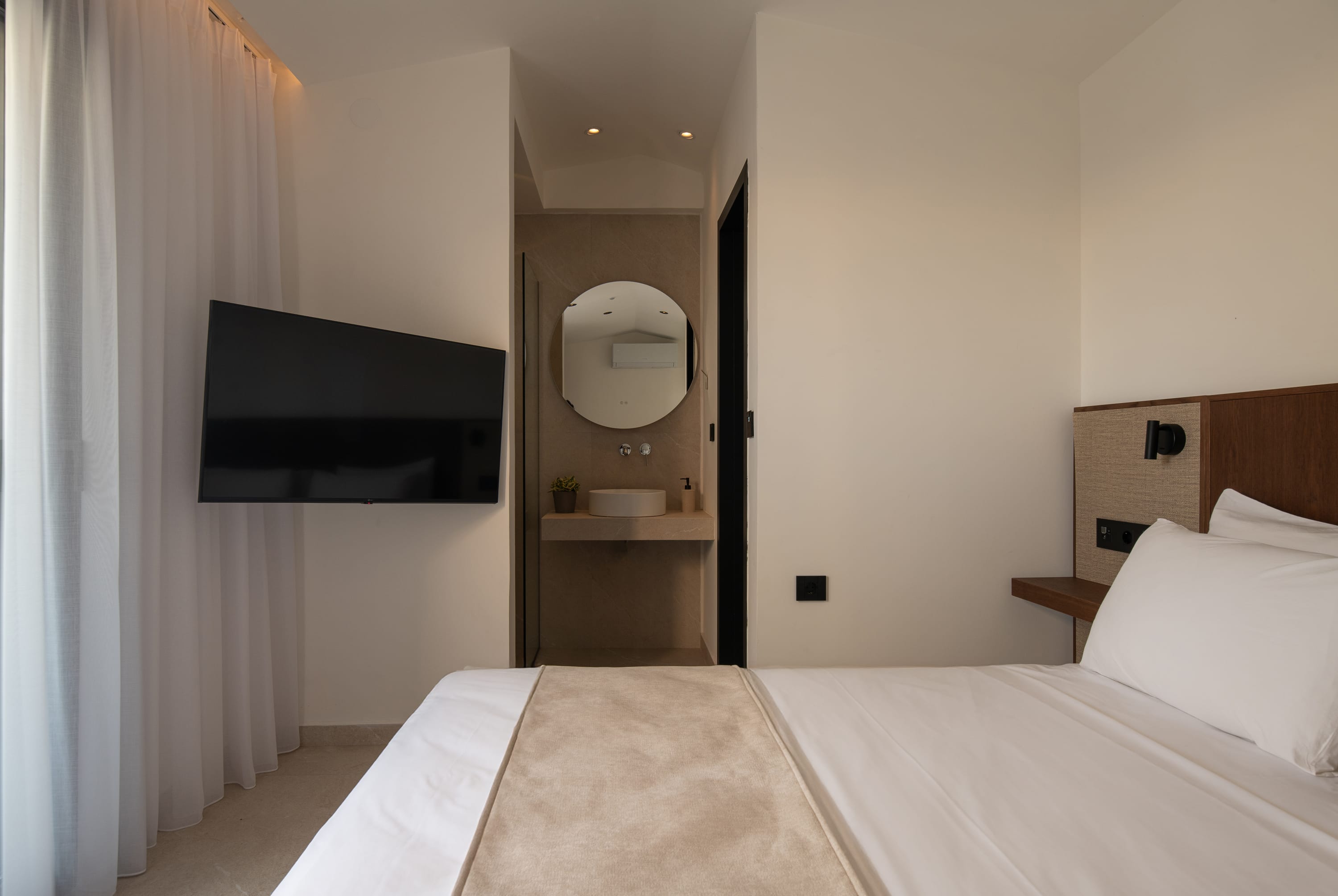 a room with a bed and a tv