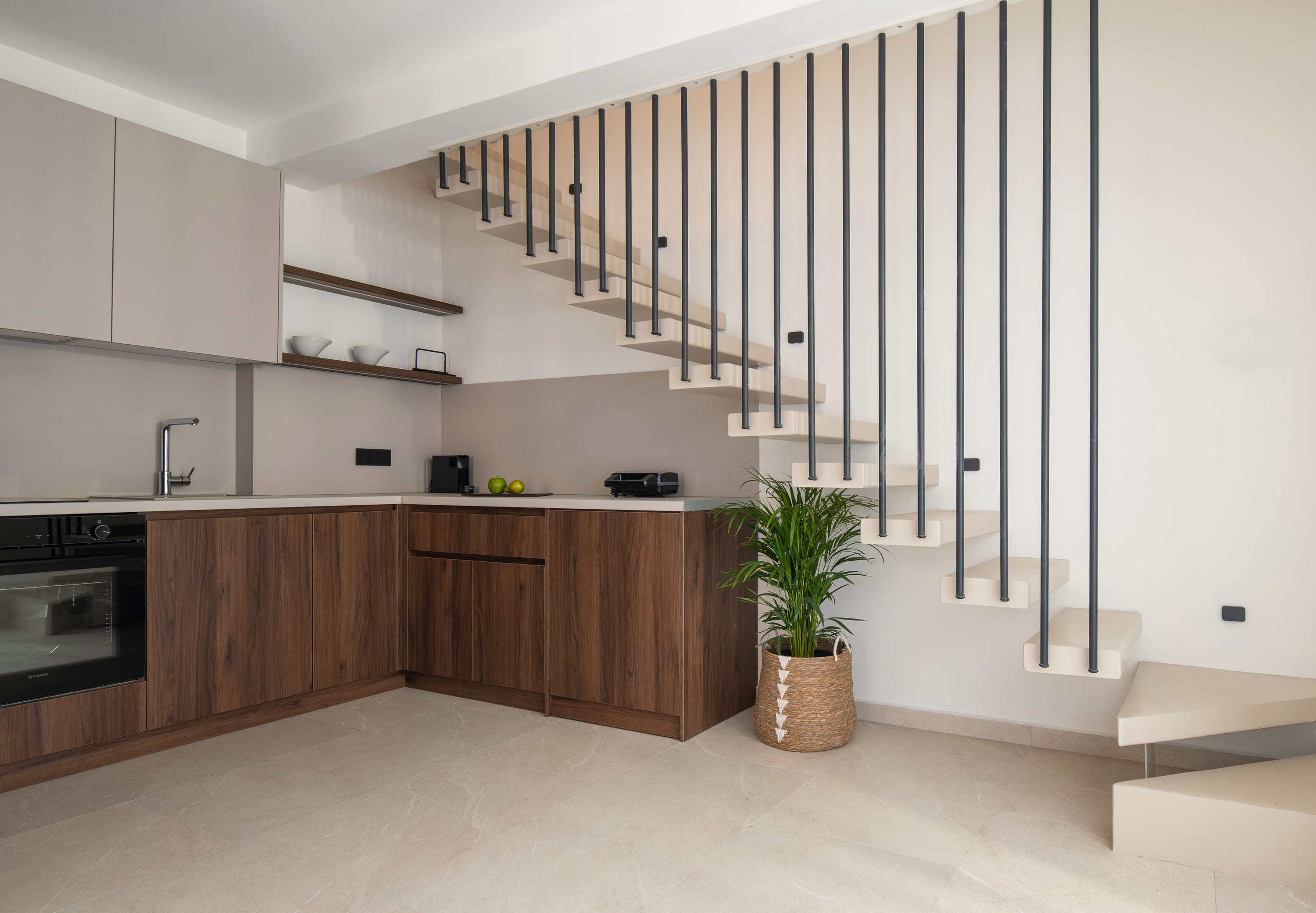 a kitchen with a staircase