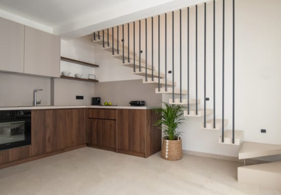 a kitchen with a staircase