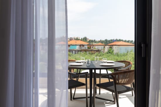 a table with plates and glasses on it by a window