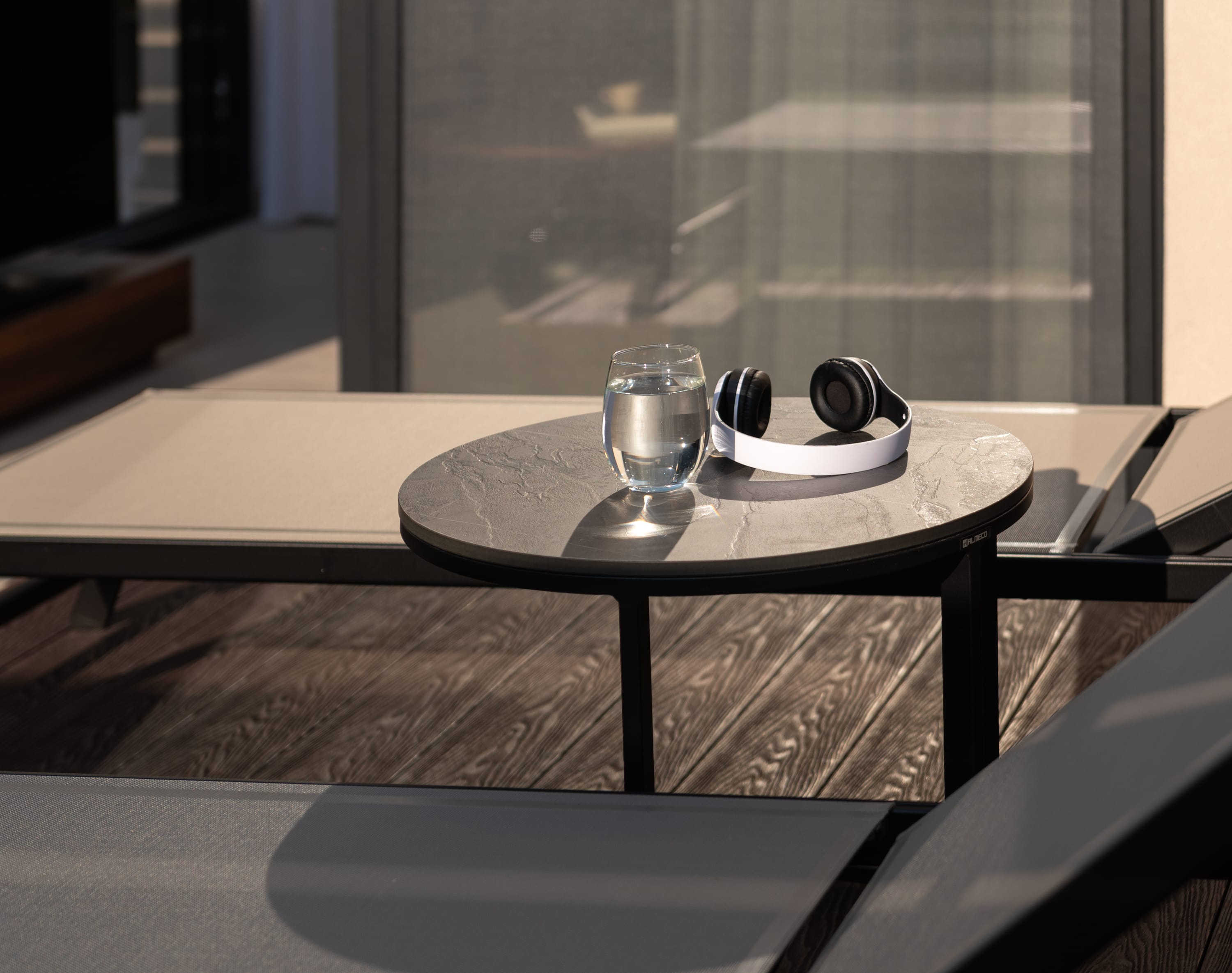 a glass coffee table with a glass cup and saucer on it