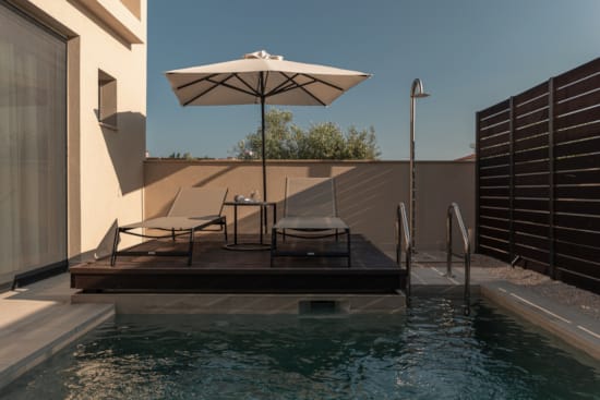 a pool with a table and chairs next to it