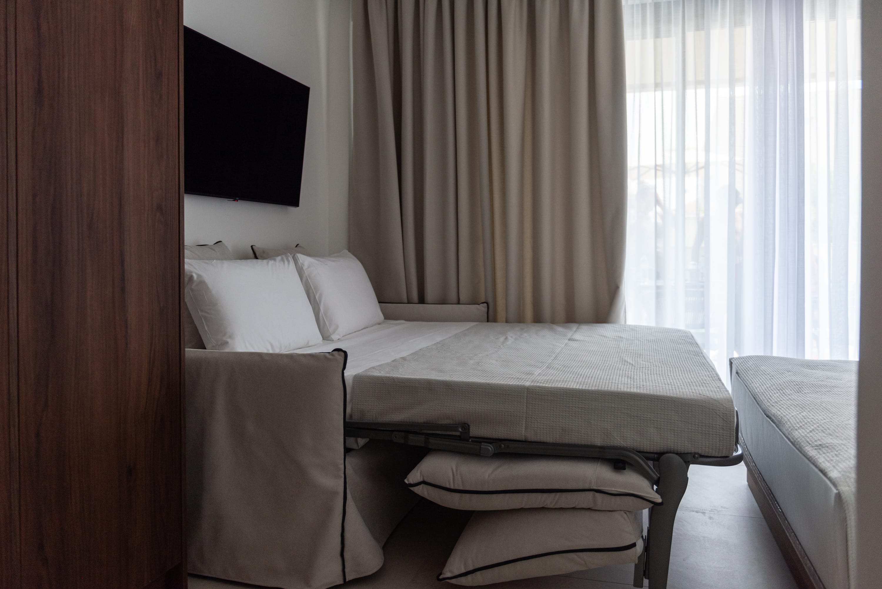 a room with a bed and a tv