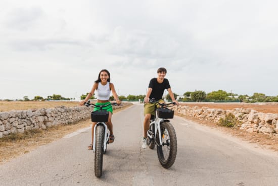 a man and a woman riding bikes