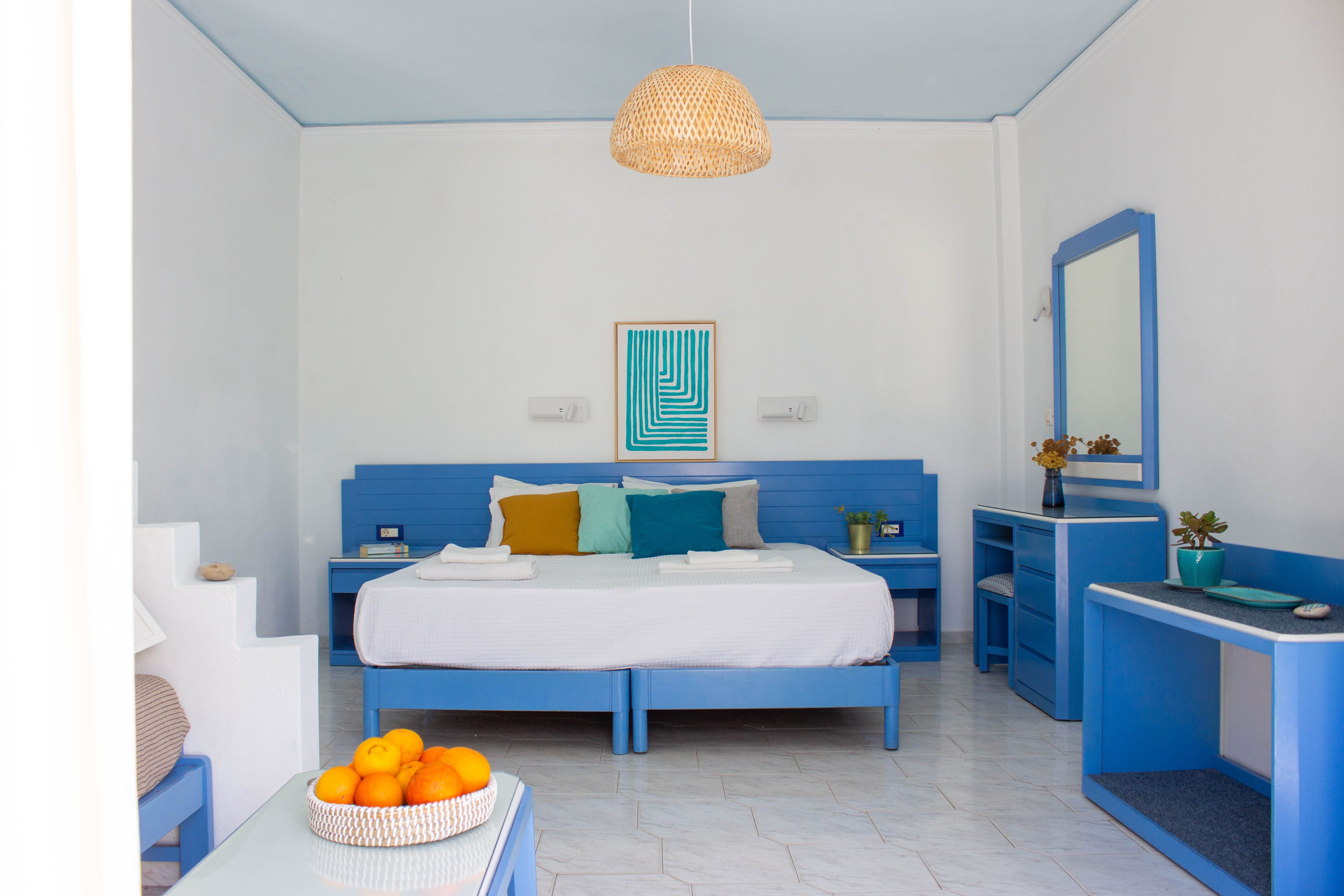 a room with a bed and a table with a lamp on it