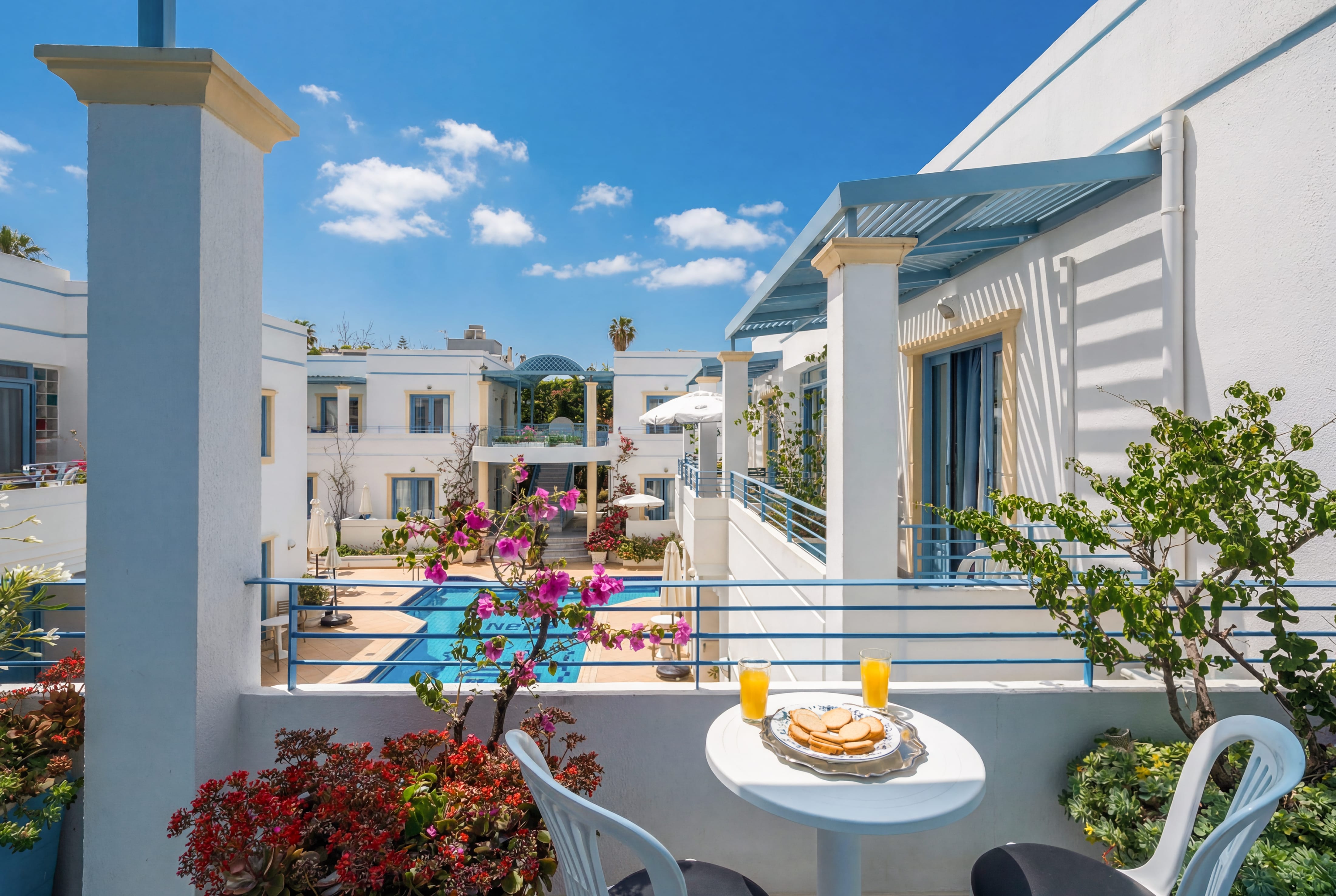 a table with food on it and a pool in the background