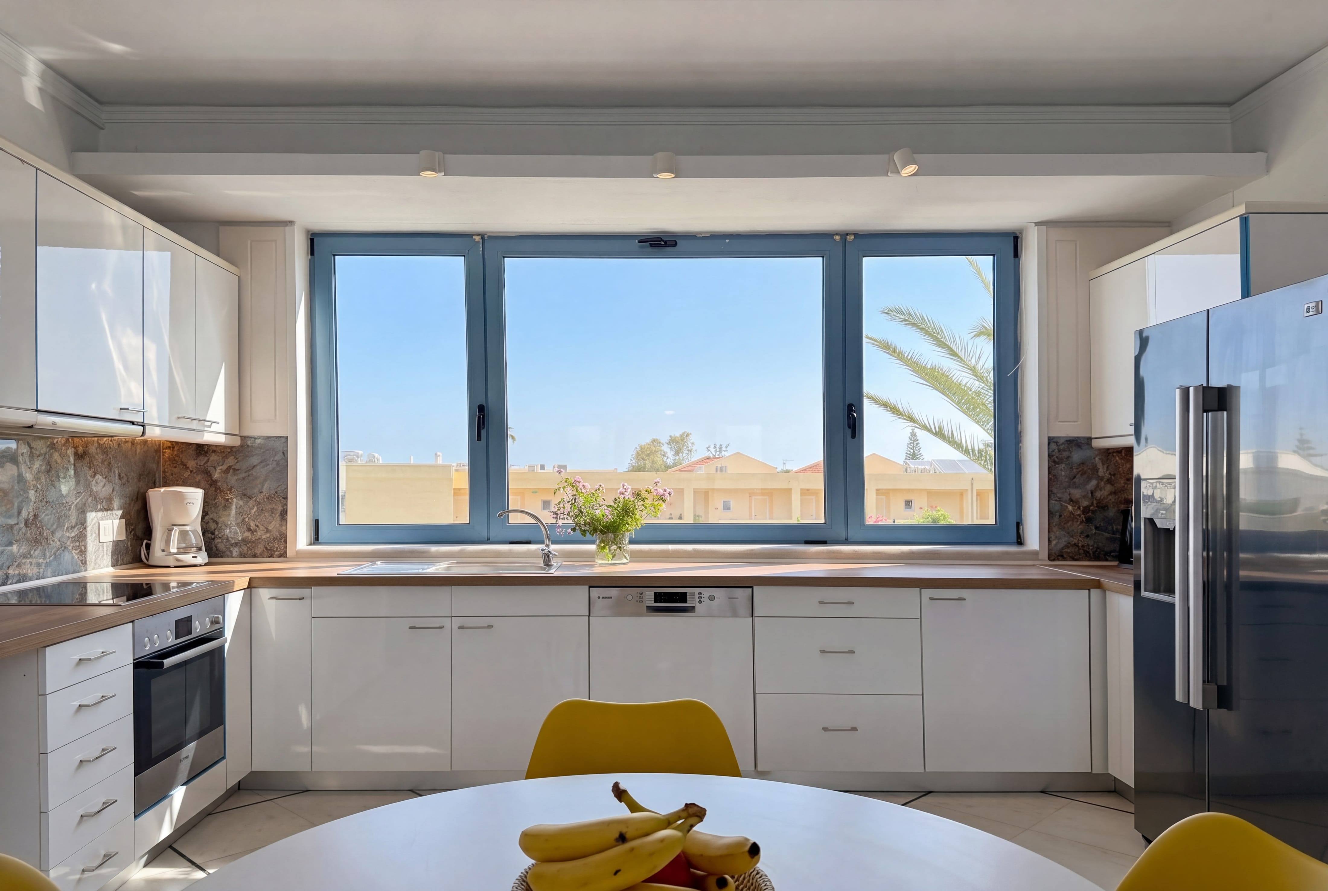 a kitchen with a table and windows