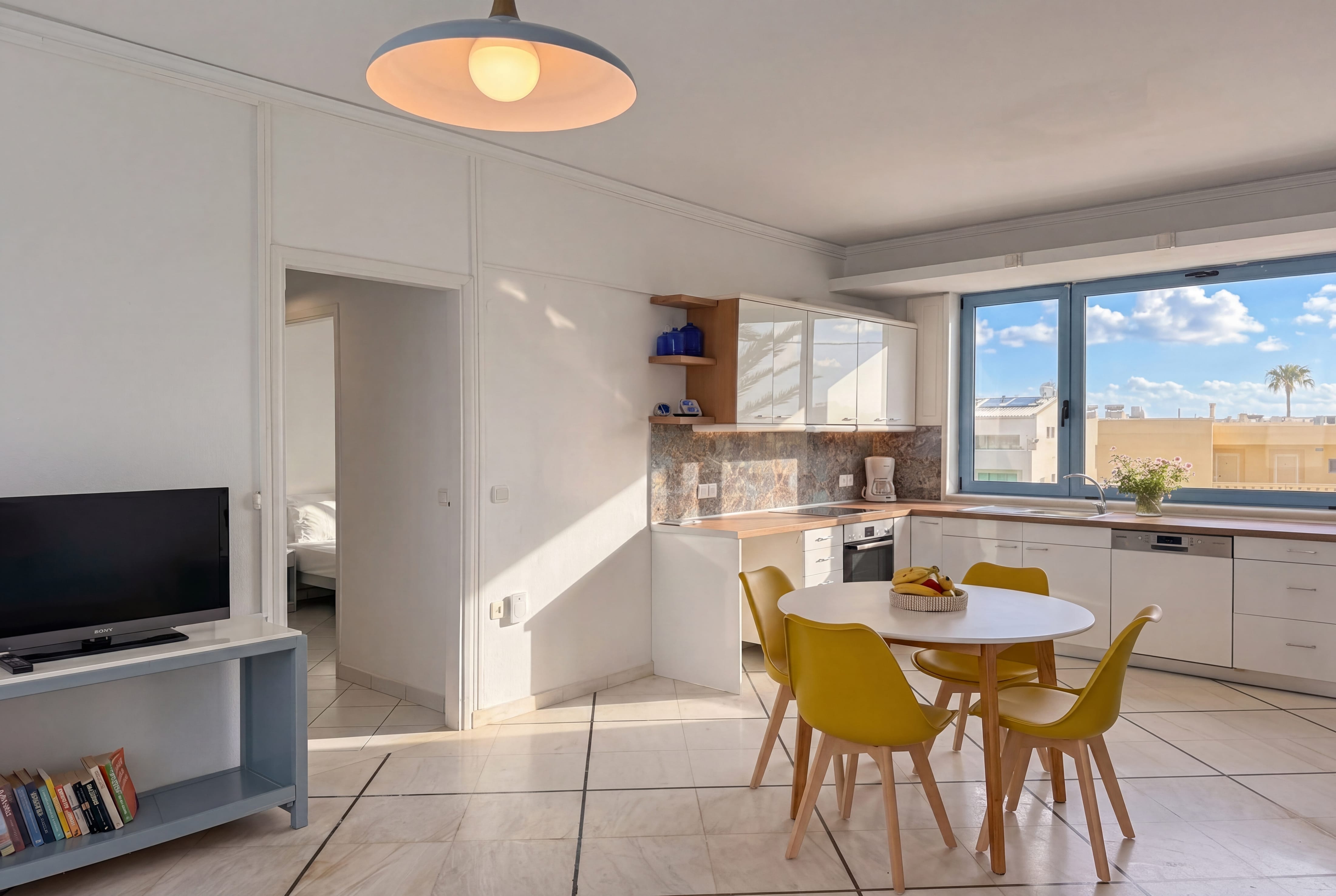 a kitchen and dining area with a table and chairs