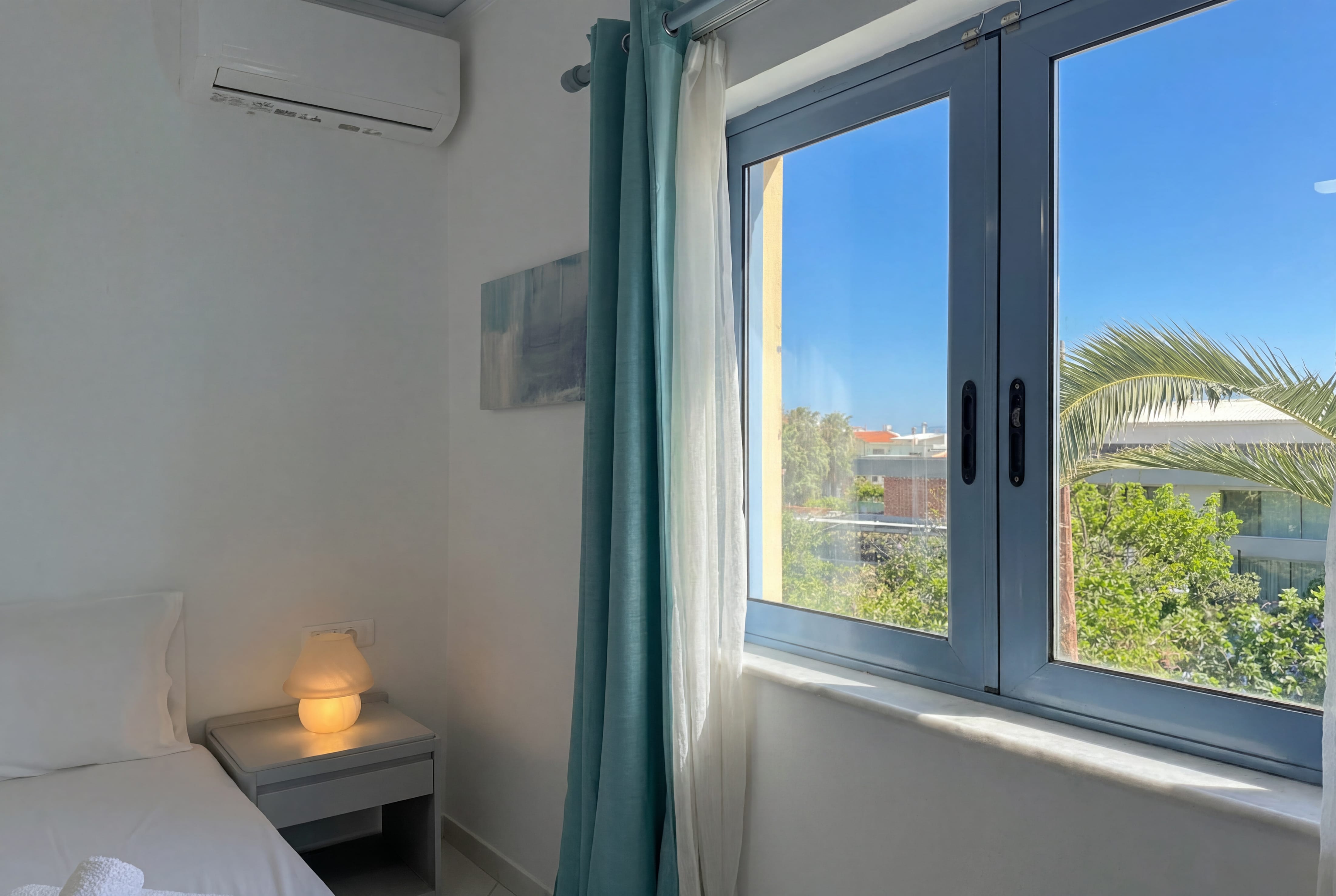 a window with a lamp and a bed