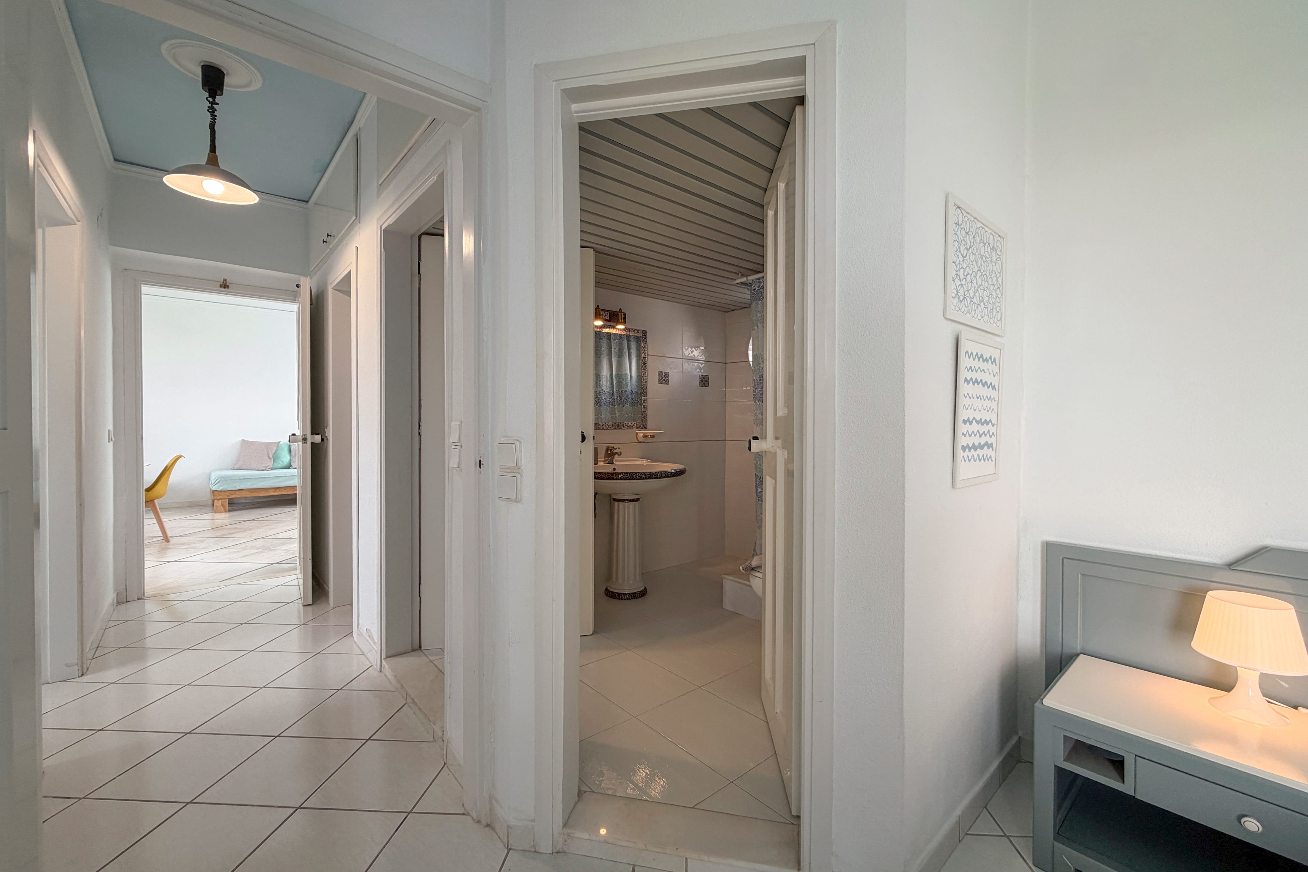 a hallway with a sink and a mirror